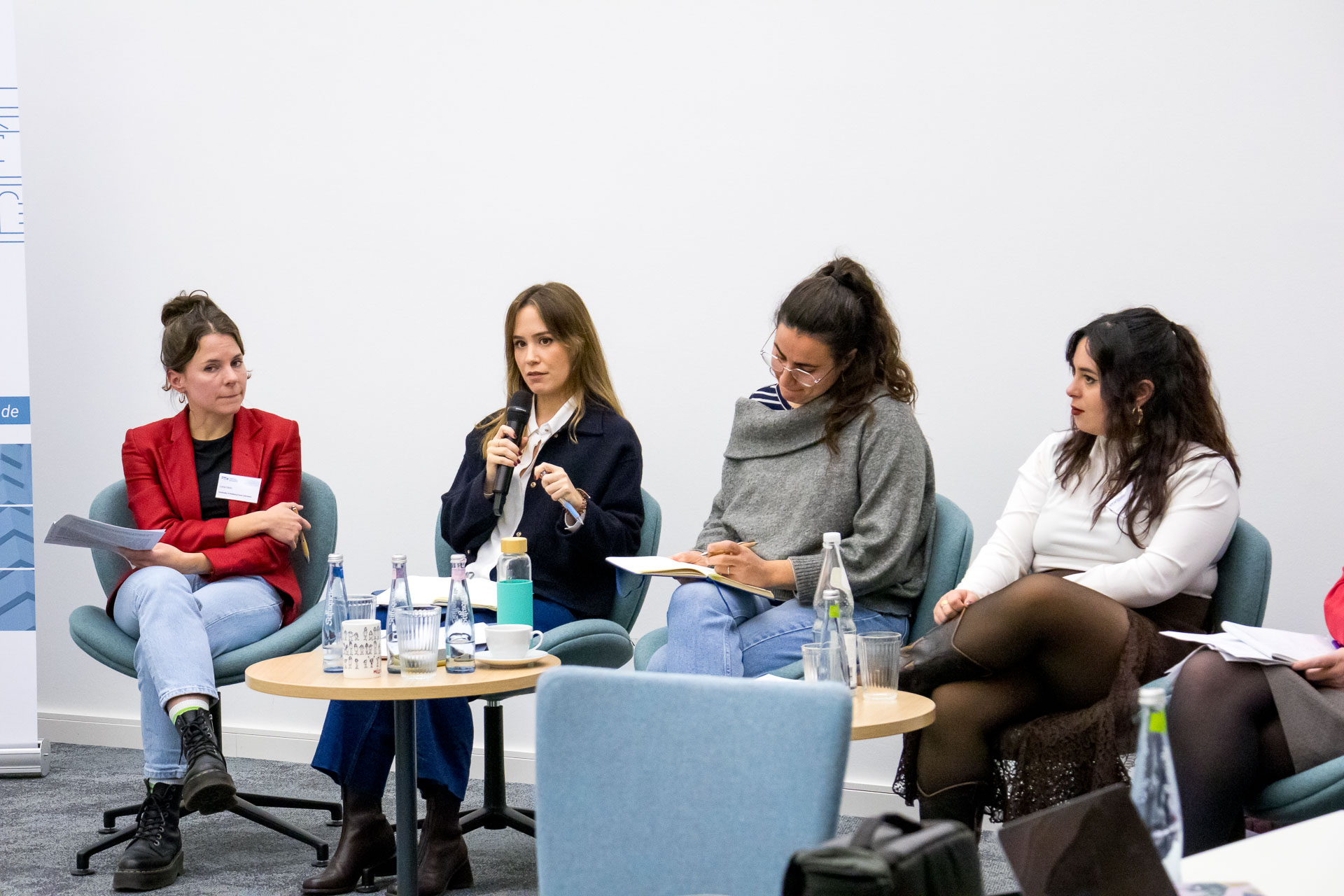 photo from the workshop 'Perpetrator Memory in Spanish culture', four panelists sitting in front of the audience, one speaking