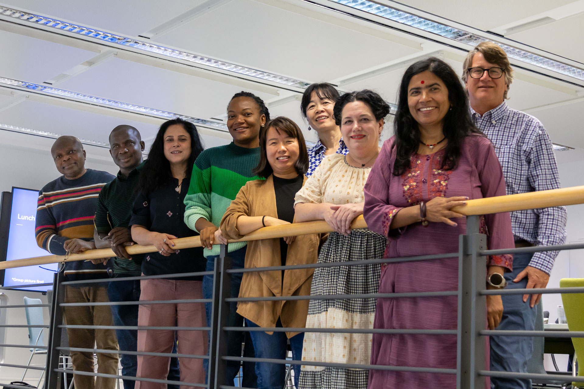 group of senior fellows leaning on a bannister