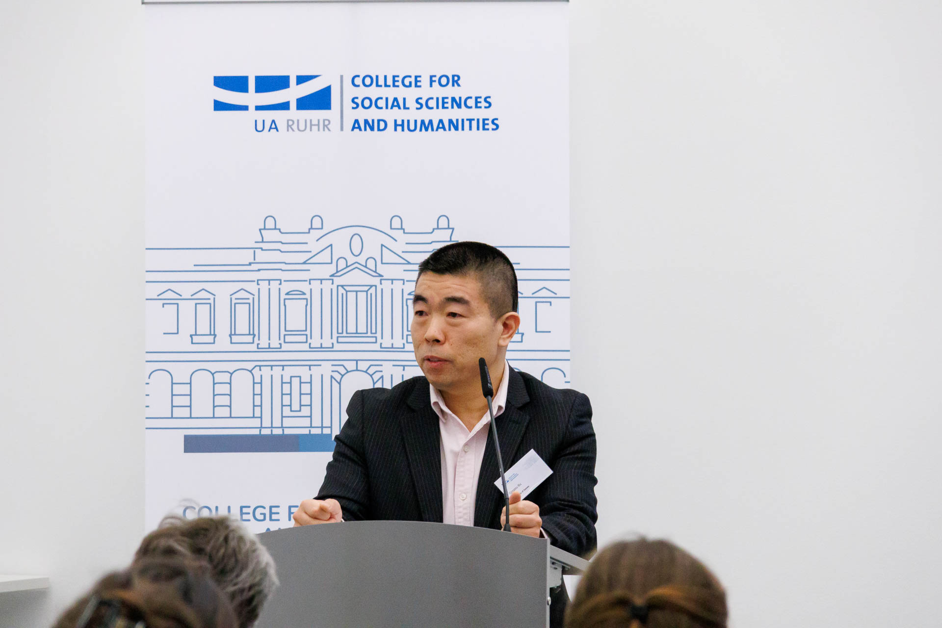 photo from the conference, Qingxiu Bu giving the welcome address