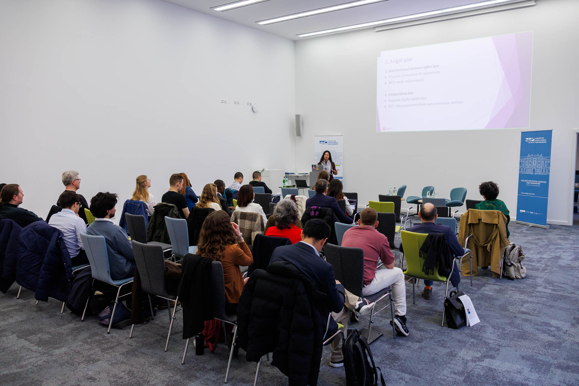 photo from the conference, speaker addressing the audience