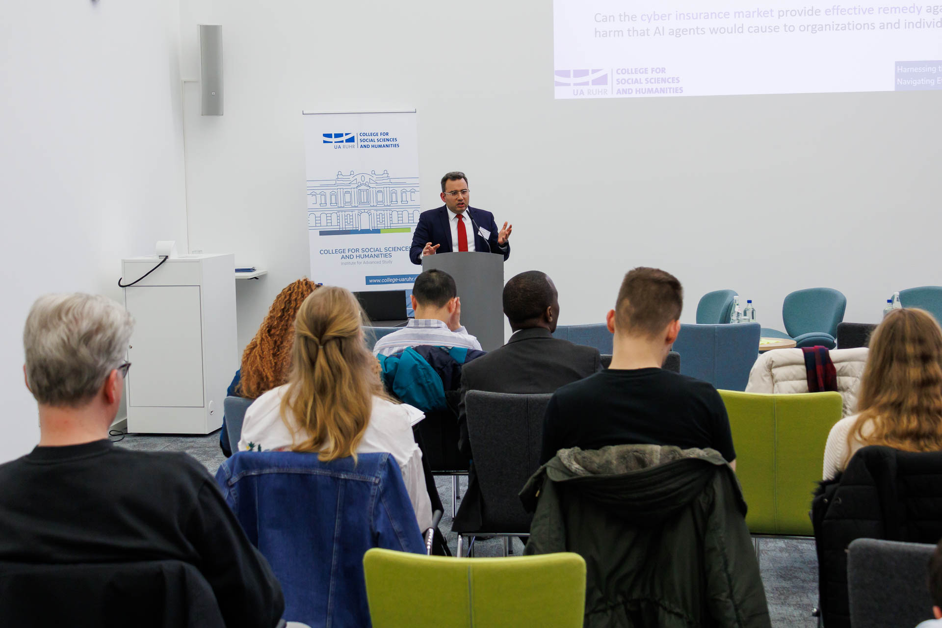 photo from the conference, speaker addressing the audience