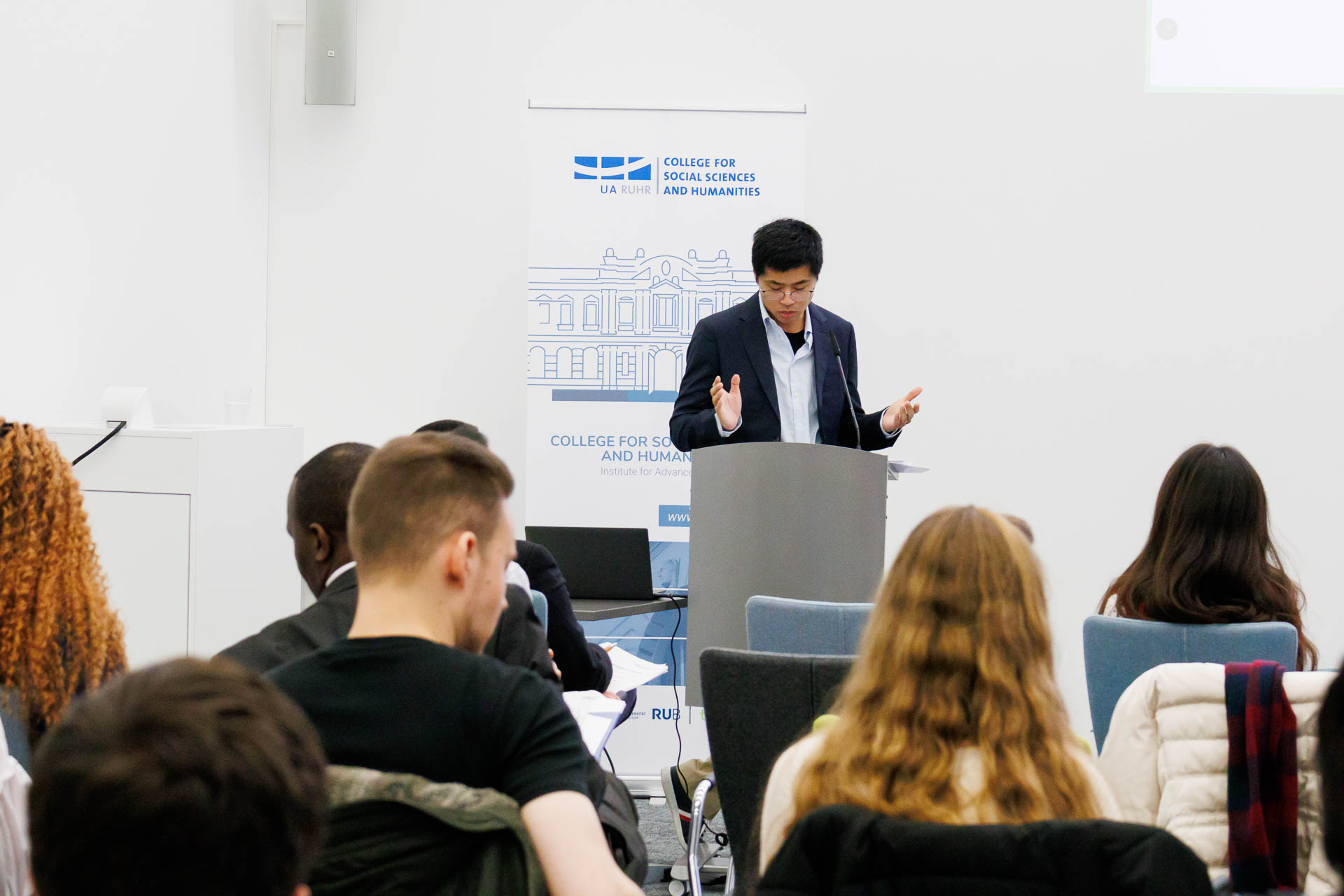 photo from the conference, speaker addressing the audience