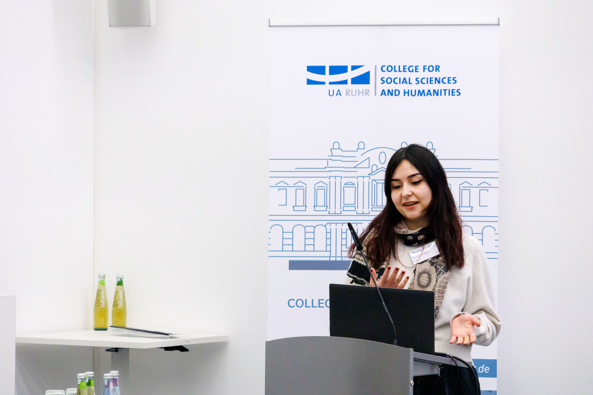 photo from the workshop 'Ethnic-Racial Socialisation', a speaker standing at a speaker's desk, gesturing